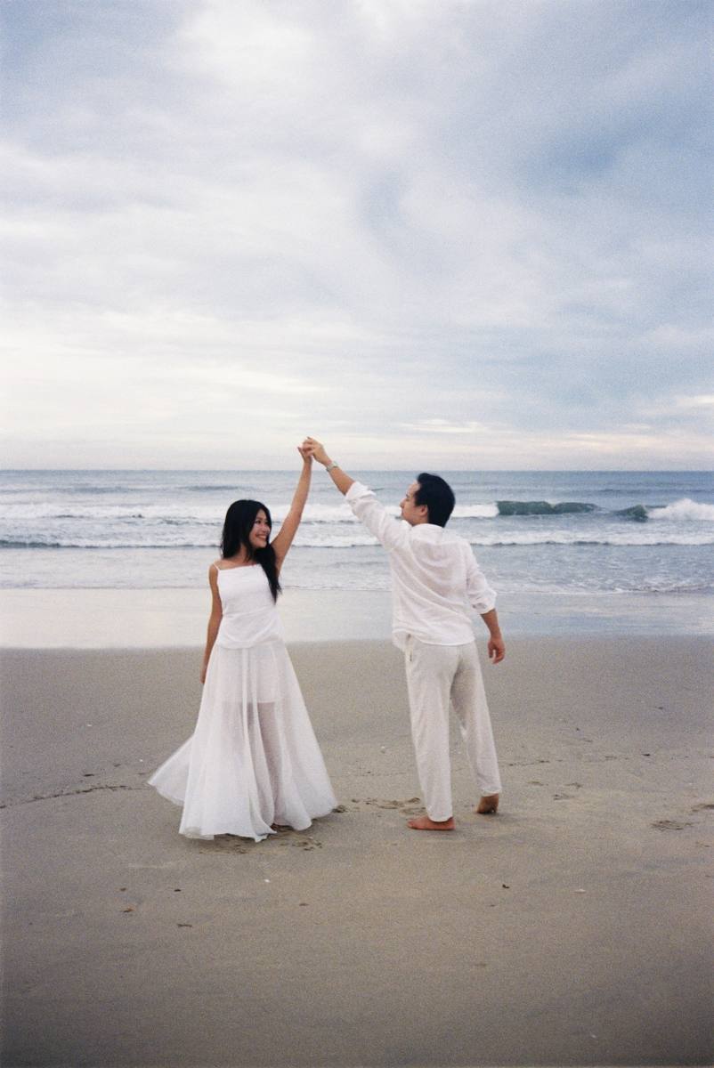 William twirling Tina on the beach